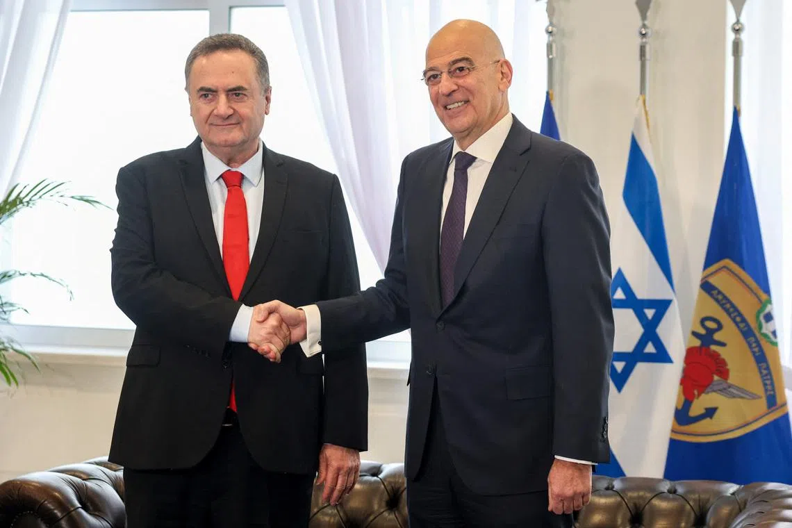 Israel's Defence Minister Israel Katz shakes hands with his Greek counterpart Nikos Dendias at the Ministry of Defence in Athens Greece, January 20, 2026. REUTERS/Louisa Gouliamaki