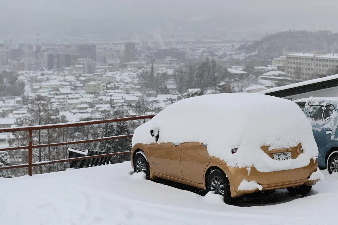 A car is covered in snow over looking Nagano city on Jan 25, 2023. Much of Japan has been blanketed in heavy snow following a cold snap.