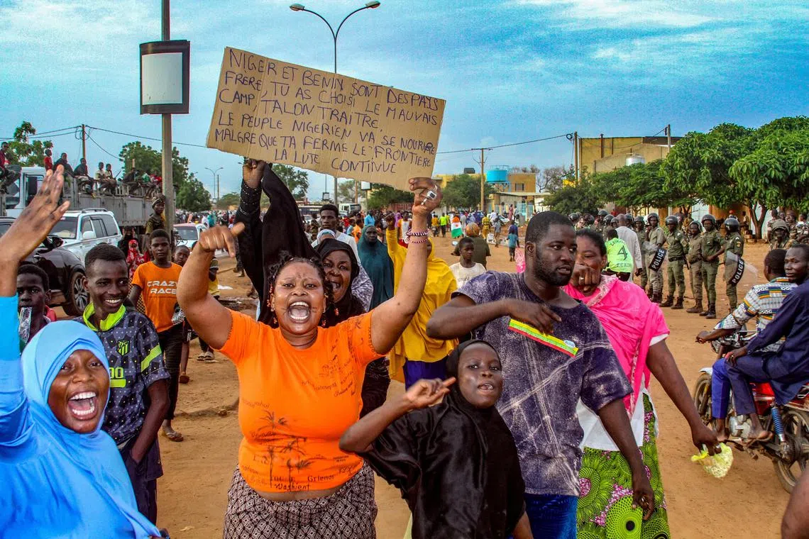 Supporters of Niger's junta take part in a demonstration in front of a French army base in Niamey, Niger.