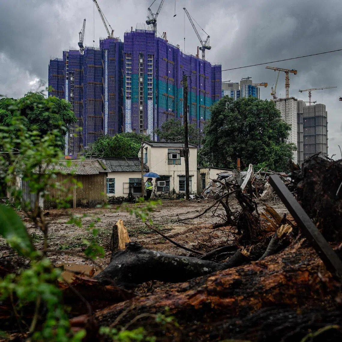 New residential developments under construction stand behind cleared land and village houses in Kwu Tung as part of Hong Kong’s Northern Metropolis development plan.