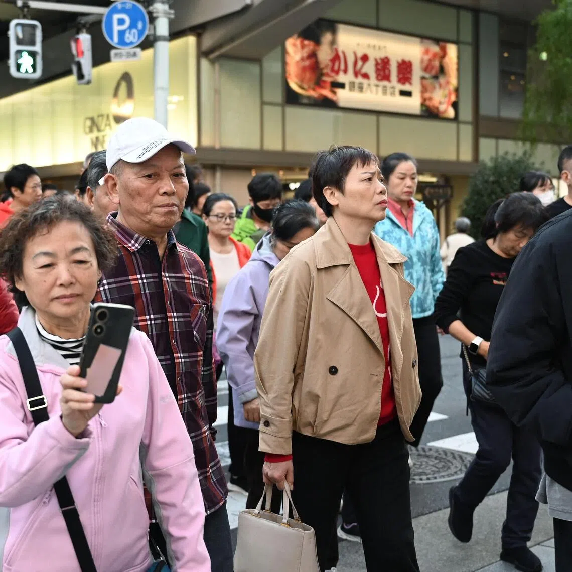 Members of a Chinese tour group in Tokyo's Ginza shopping district on Nov 17.