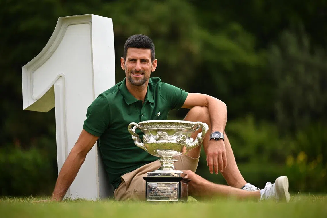 Austratian Open men's singles champion Novak Djokovic posing with the Norman Brooks Challenge Cup at Government House a day after winning his 10th title in Melbourne. 