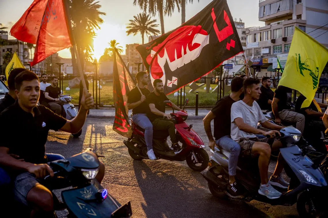 Supporters of Hamas and Hezbollah drive through the streets of Saida, Lebanon, following tributes for the slain Hamas leader Ismail Haniyeh.
