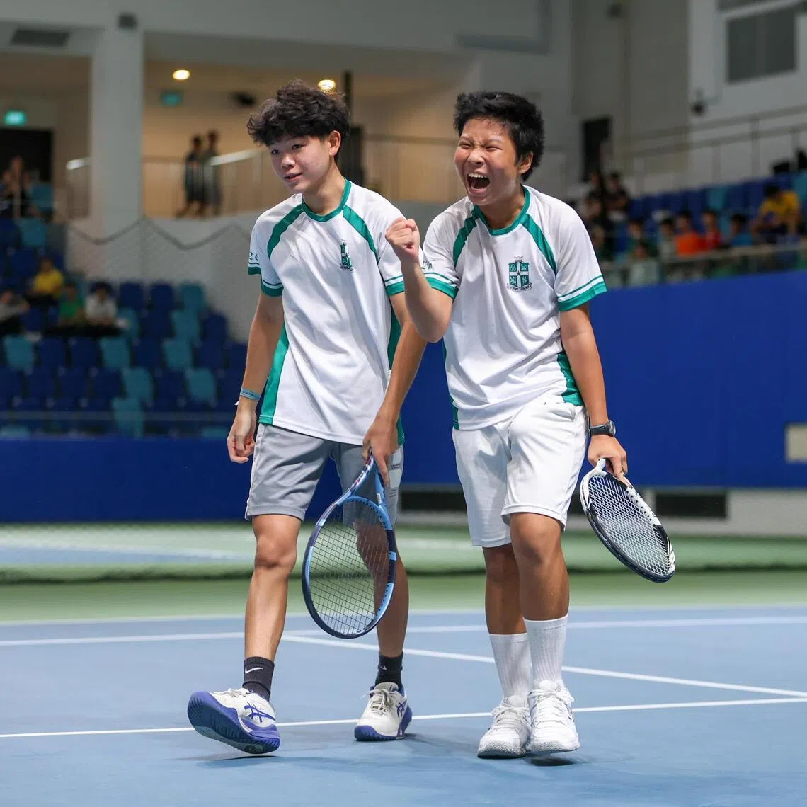 St Joseph's Institution's Noah Khoo (left) and Takuya Kaneko celebrate after winning the National School Games B Division Tennis Boys' Final at Kallang Tennis Hub on Mar 4.