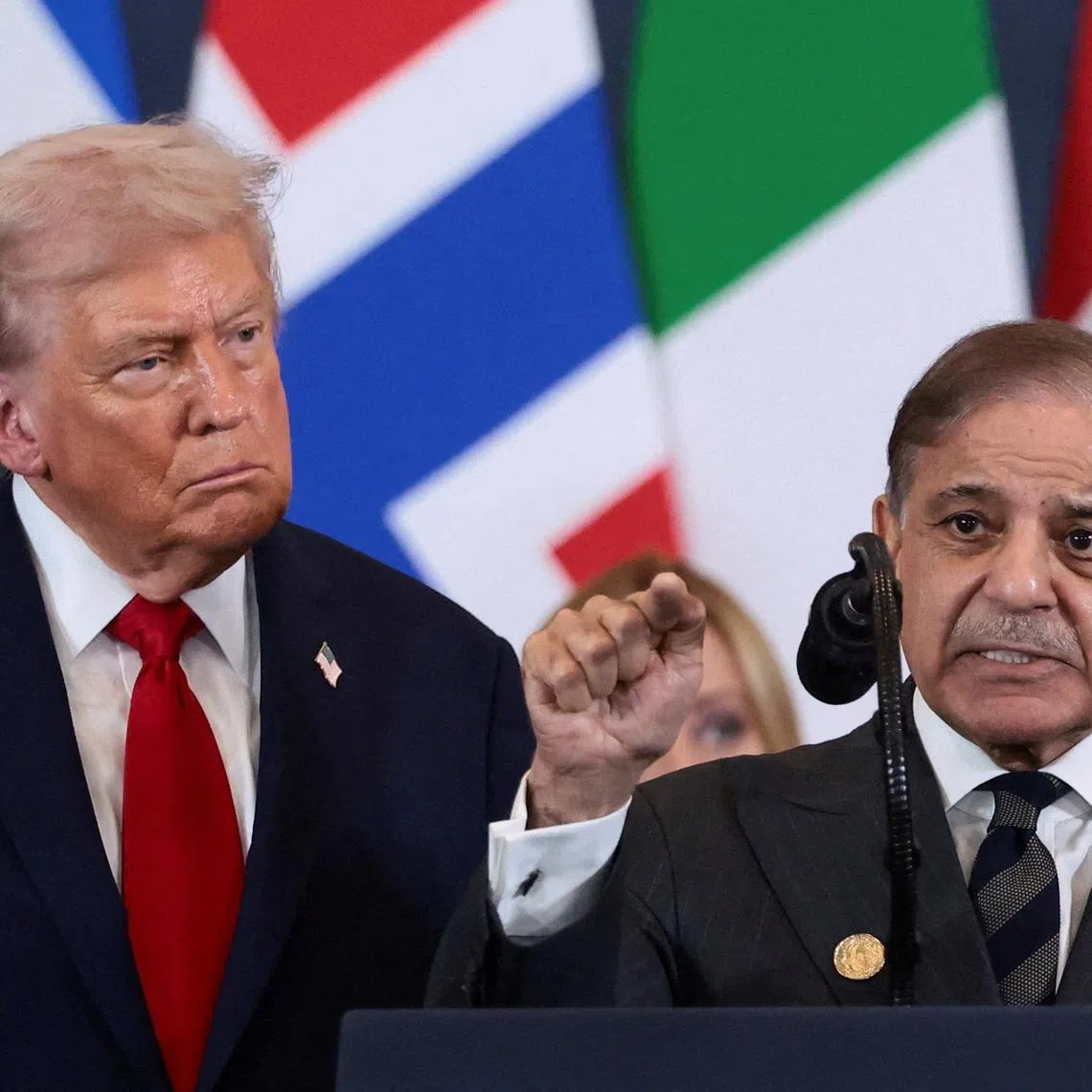 FILE PHOTO: U.S. President Donald Trump looks at Pakistan's Prime Minister Shehbaz Sharif speaking following the official signing of the first phase of the Gaza ceasefire agreement between Israel and Hamas, during a world leaders' summit on ending the Gaza war, in Sharm El-Sheikh, Egypt, October 13, 2025. REUTERS/Evelyn Hockstein/File Photo