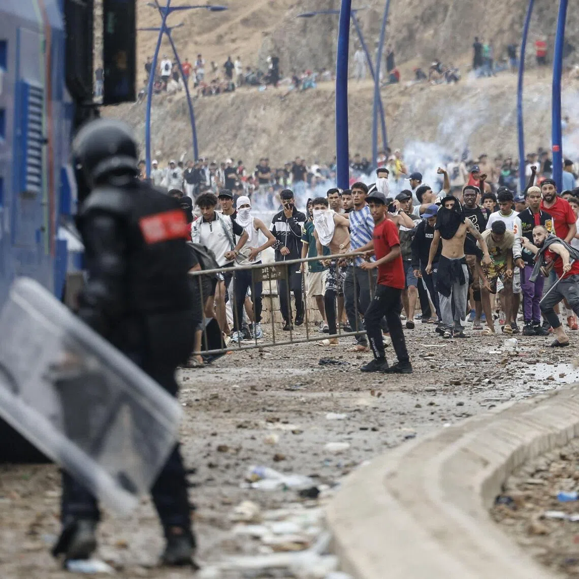 Moroccan security forces clash with migrants attempting to cross into Spain’s North African enclave of Ceuta on July 31.