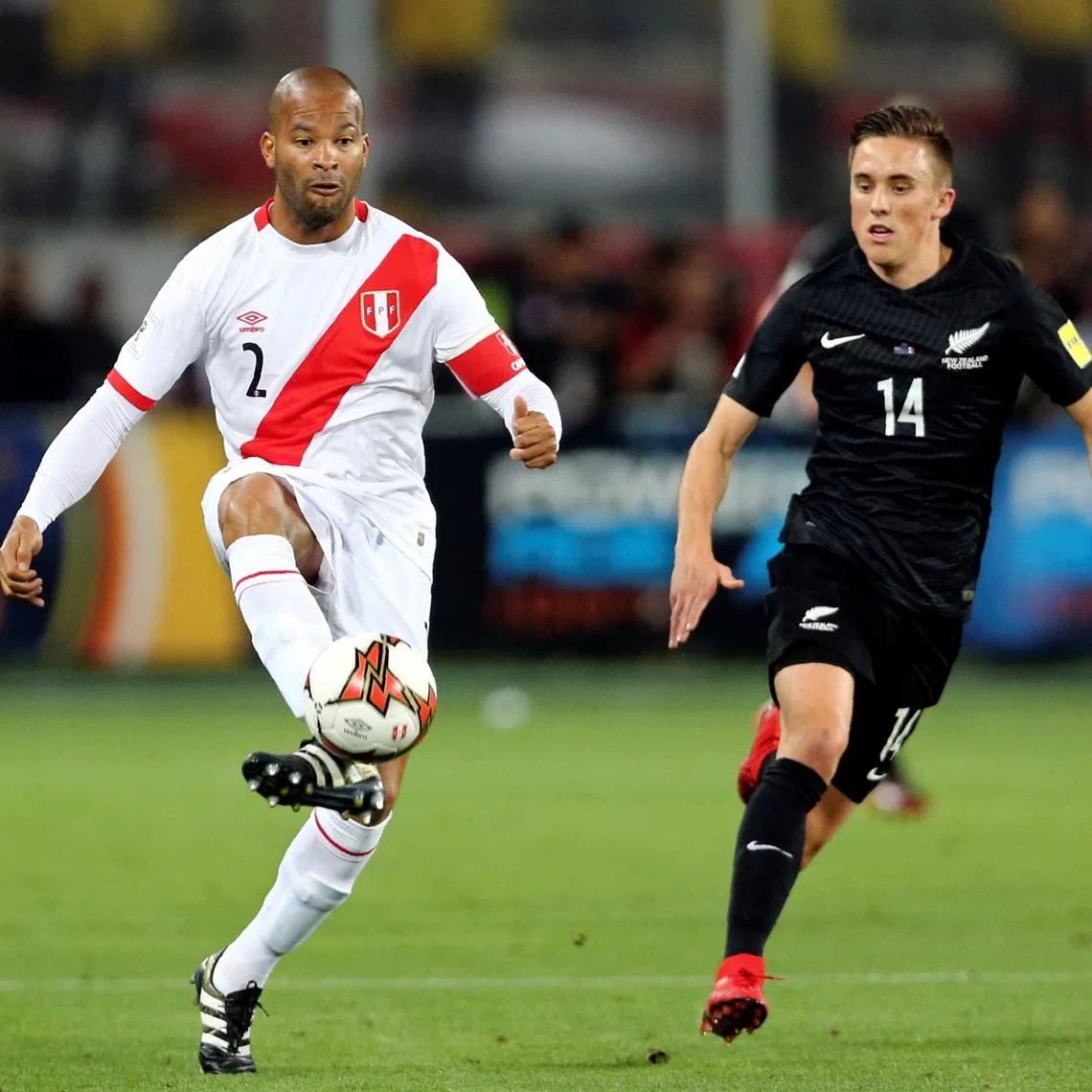 Soccer Football - Peru v New Zealand - 2018 World Cup Qualifying Playoffs - National Stadium, Lima, Peru - November 15, 2017. Peru's Alberto Rodriguez and New Zealand's Ryan Thomas fight for the ball. REUTERS/Mariana Bazo