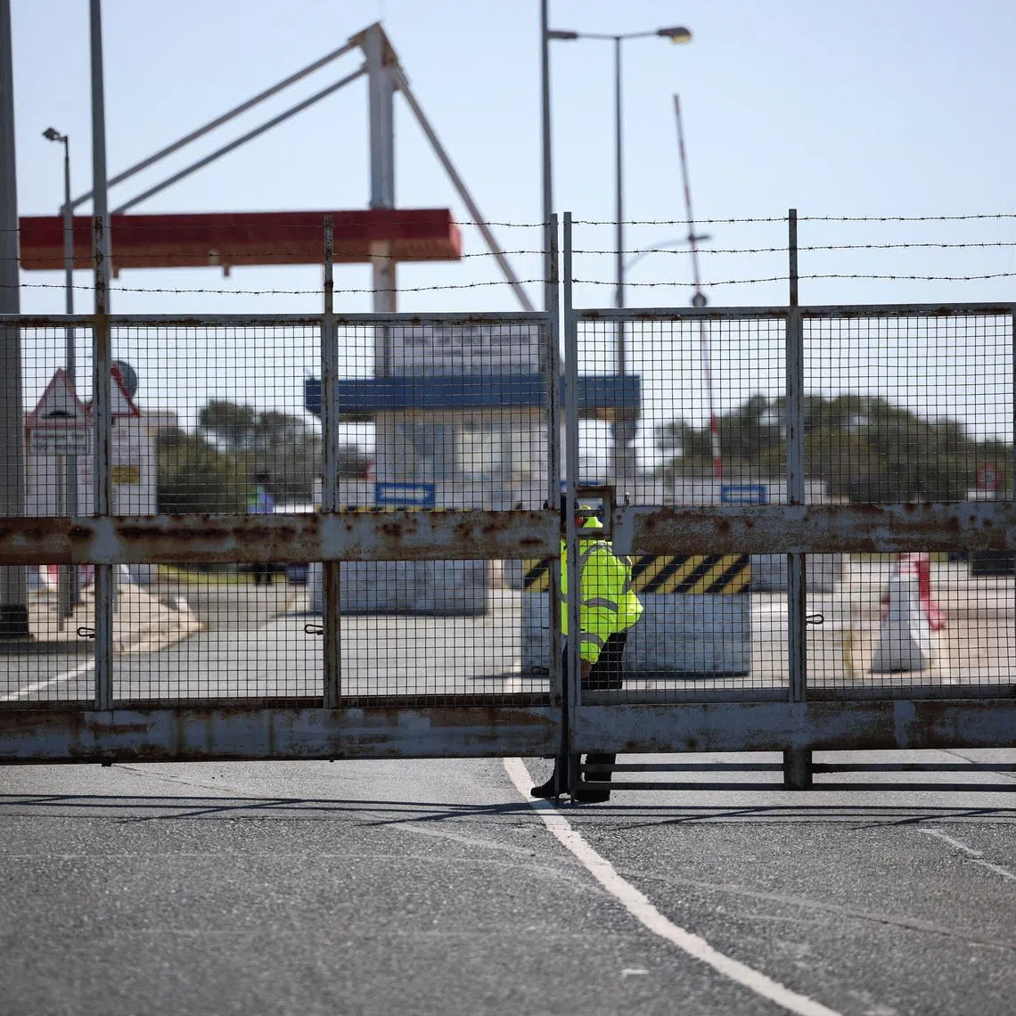 A police officer closes the entrance of RAF Akrotiri, a British sovereign base in Cyprus, which was hit by an unmanned drone overnight, causing limited damage, Cyprus March 2, 2026. REUTERS/Yiannis Kourtoglou