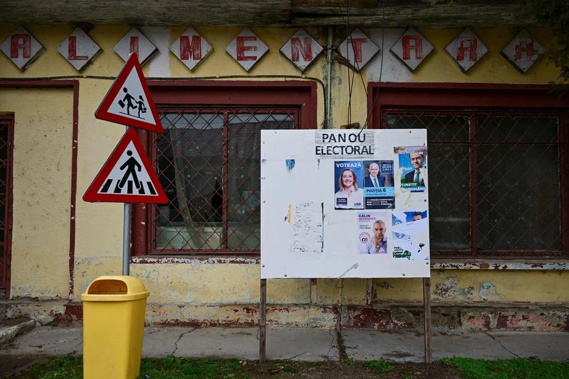 An electoral display in front of an abandoned grocery store in Mihai Viteazu village in Romania on Dec 4.