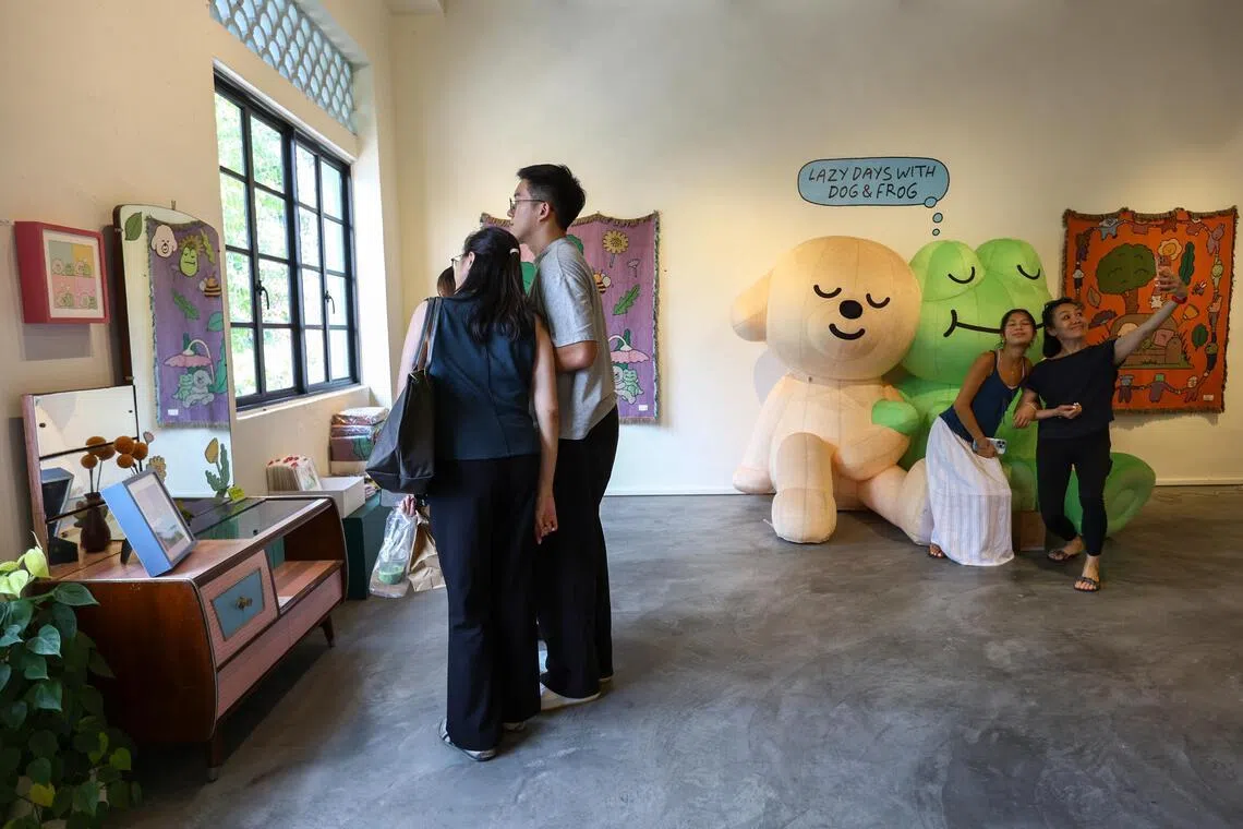 Visitors at the Heartware Store & Gallery admire art by Irish comic artist Niall Breen, taken on July 18.