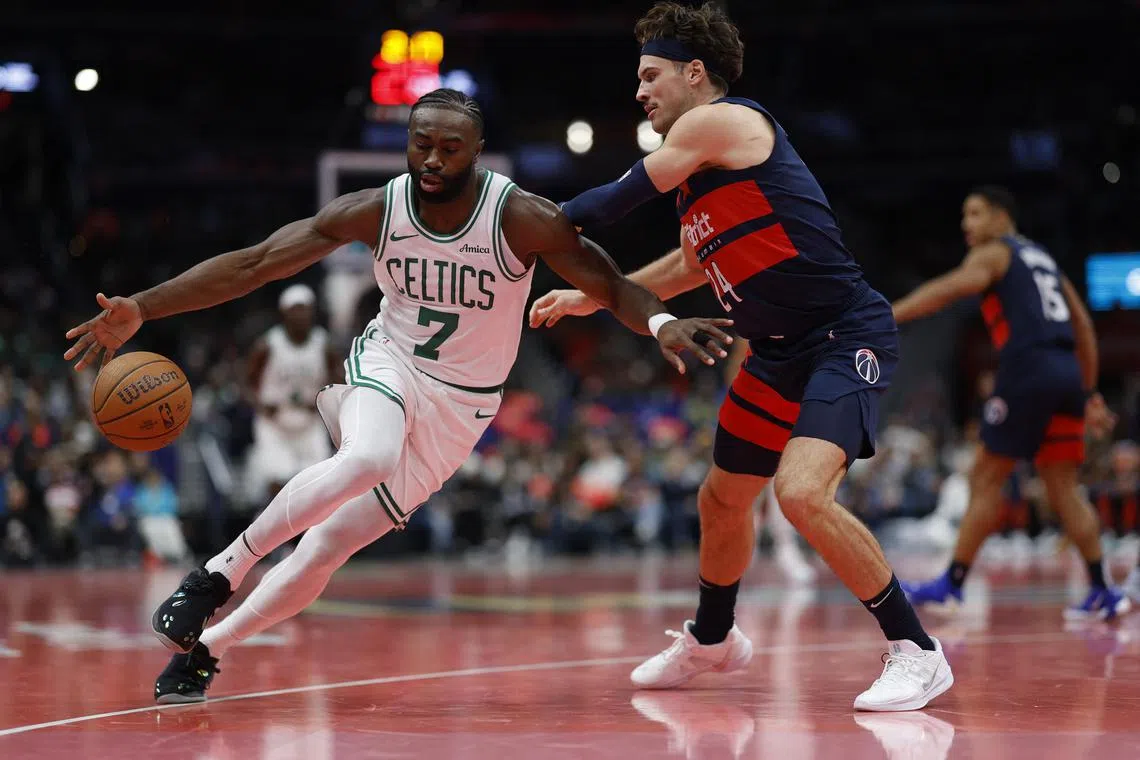 Boston Celtics guard Jaylen Brown dribbles the ball as Washington Wizards forward Corey Kispert defends in the first half at Capital One Arena.