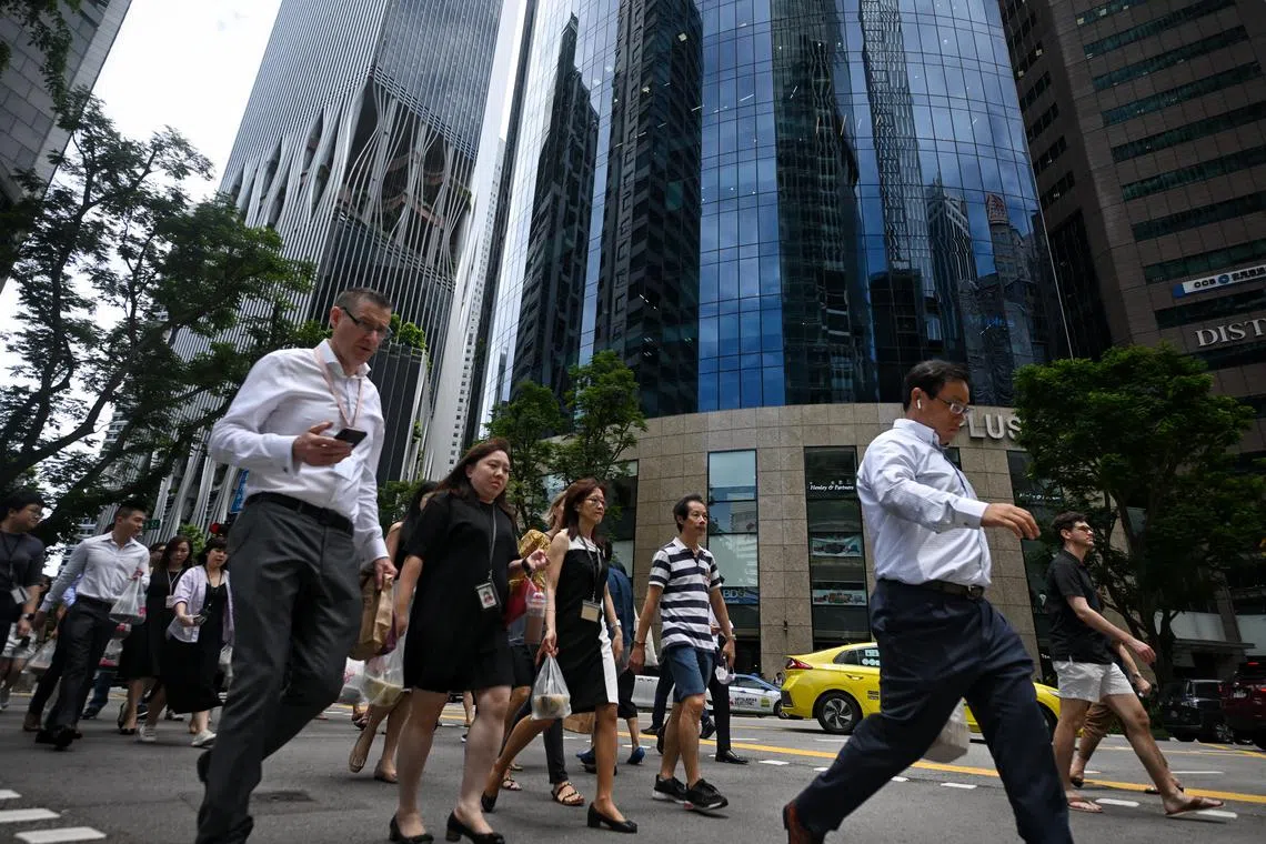 Generic pix of office workers crossing a traffic junction along Cecil Street in the Central Business District (CBD) during lunchtime on May 09, 2023.
