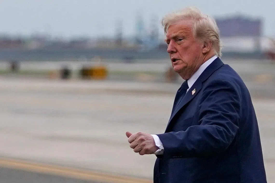 U.S. President Donald Trump gestures upon arrival at Newark Liberty International Airport, after attending Pope Francis' funeral, in Newark, New Jersey, U.S., April 26, 2025. REUTERS/Nathan Howard