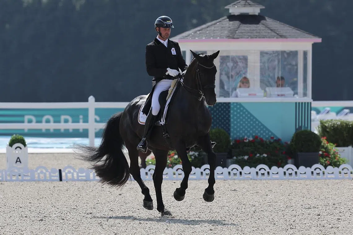 FILE PHOTO: Paris 2024 Olympics - Equestrian - Dressage Individual Grand Prix Day 2 - Chateau de Versailles, Versailles, France - July 31, 2024. Domien Michiels of Belgium riding Intermezzo VH Meerdaalhof in action. REUTERS/Zohra Bensemra/ File Photo
