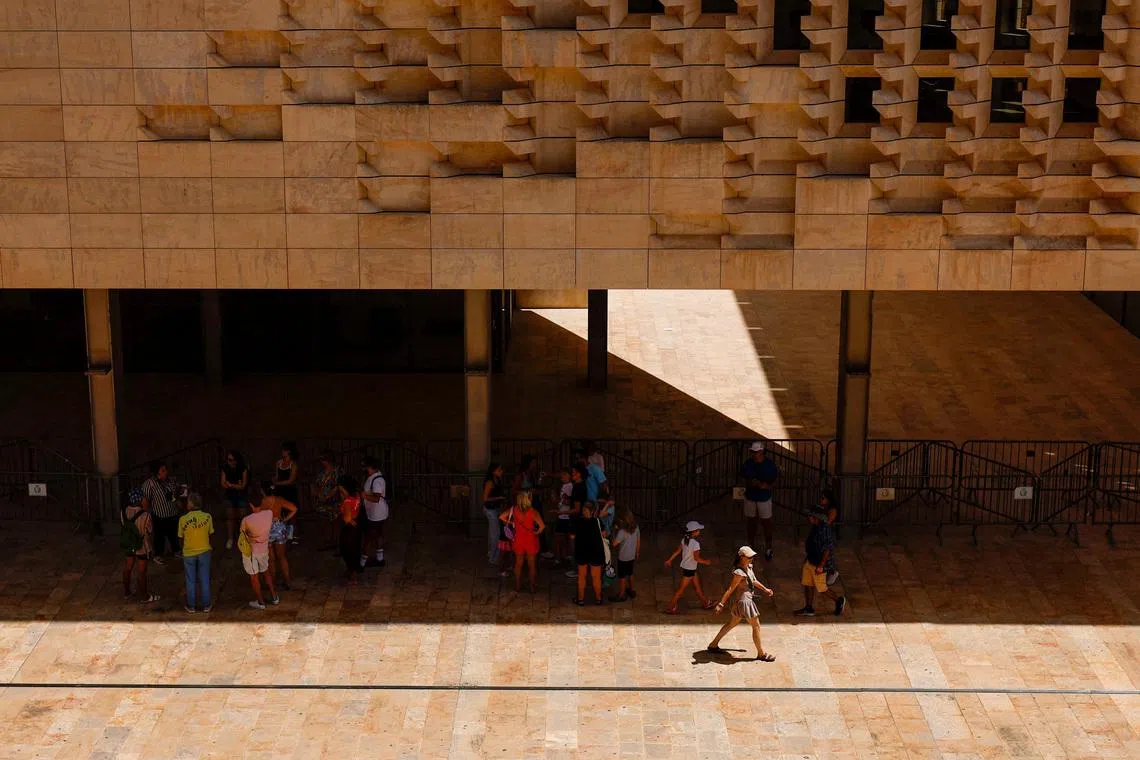 People shelter from the sun outside Parliament House during a heatwave, in Valletta, Malta July 18, 2026. REUTERS/Darrin Zammit Lupi