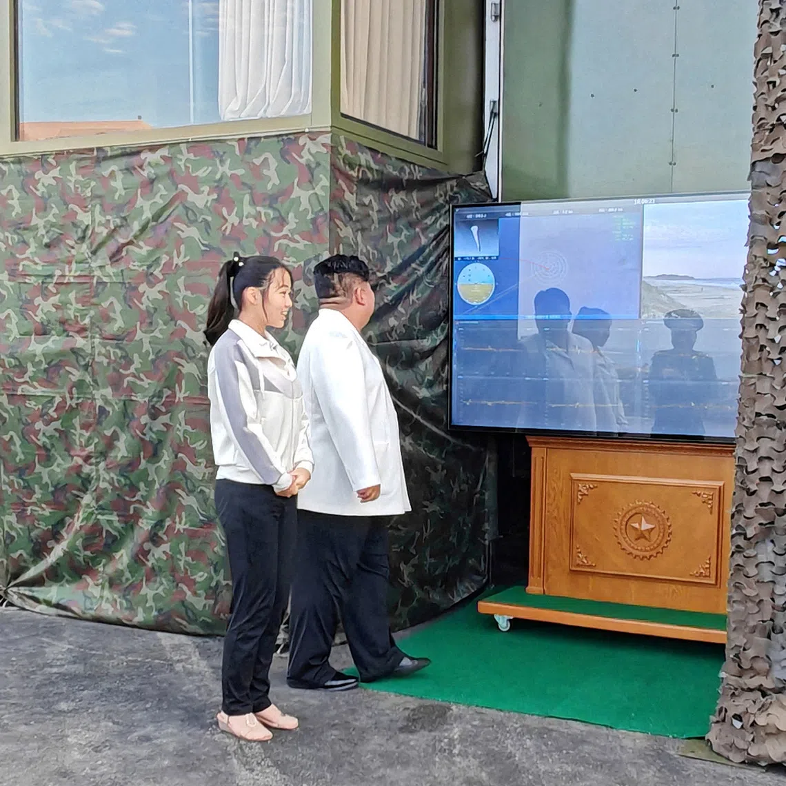 North Korean leader Kim Jong Un, accompanied by his daughter Kim Ju Ae, attending a test of a new type of weapon at an undisclosed location in North Korea on Sept 20.