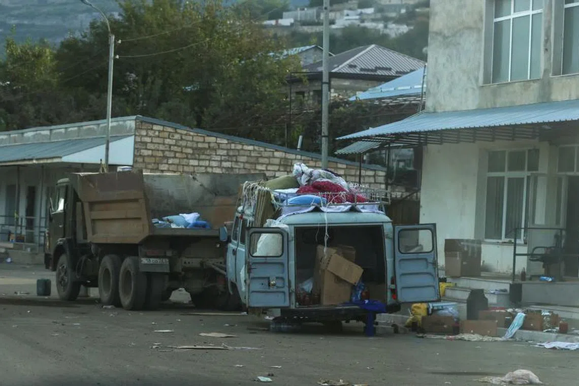 FILE PHOTO: A view through a car window shows abandoned vehicles in Stepanakert city, known as Khankendi by Azerbaijan, following an Azeri military operation and a further mass exodus of ethnic Armenians from the region of Nagorno-Karabakh, October 2, 2023. REUTERS/Aziz Karimov/File Photo