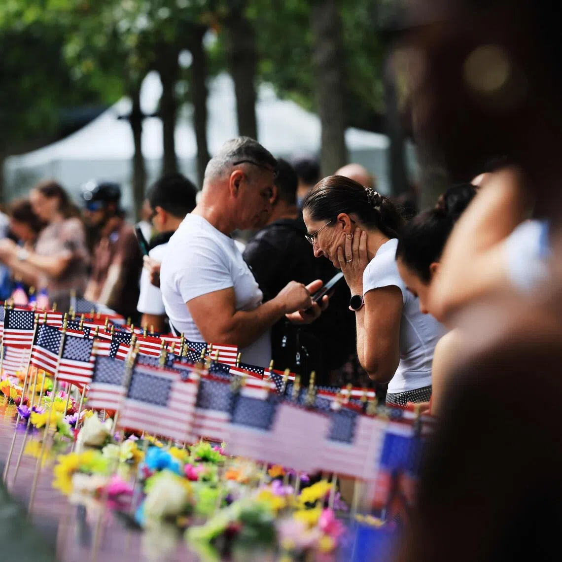 People walk through the September 11 Memorial site a day before commemorations to mark the day of the attacks on Sept 10.