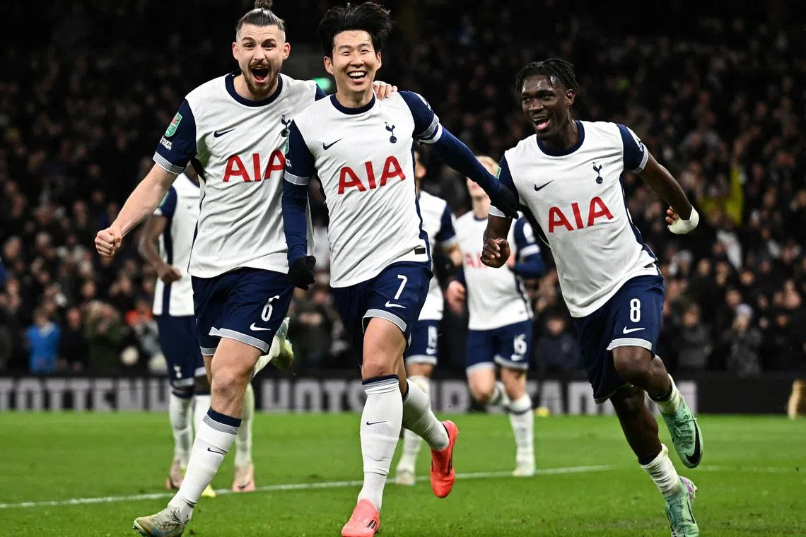 Tottenham Hotspur's Son Heung-min celebrates scoring their fourth goal with Radu Dragusin and Yves Bissouma in the 4-3 League Cup win over Manchester United.