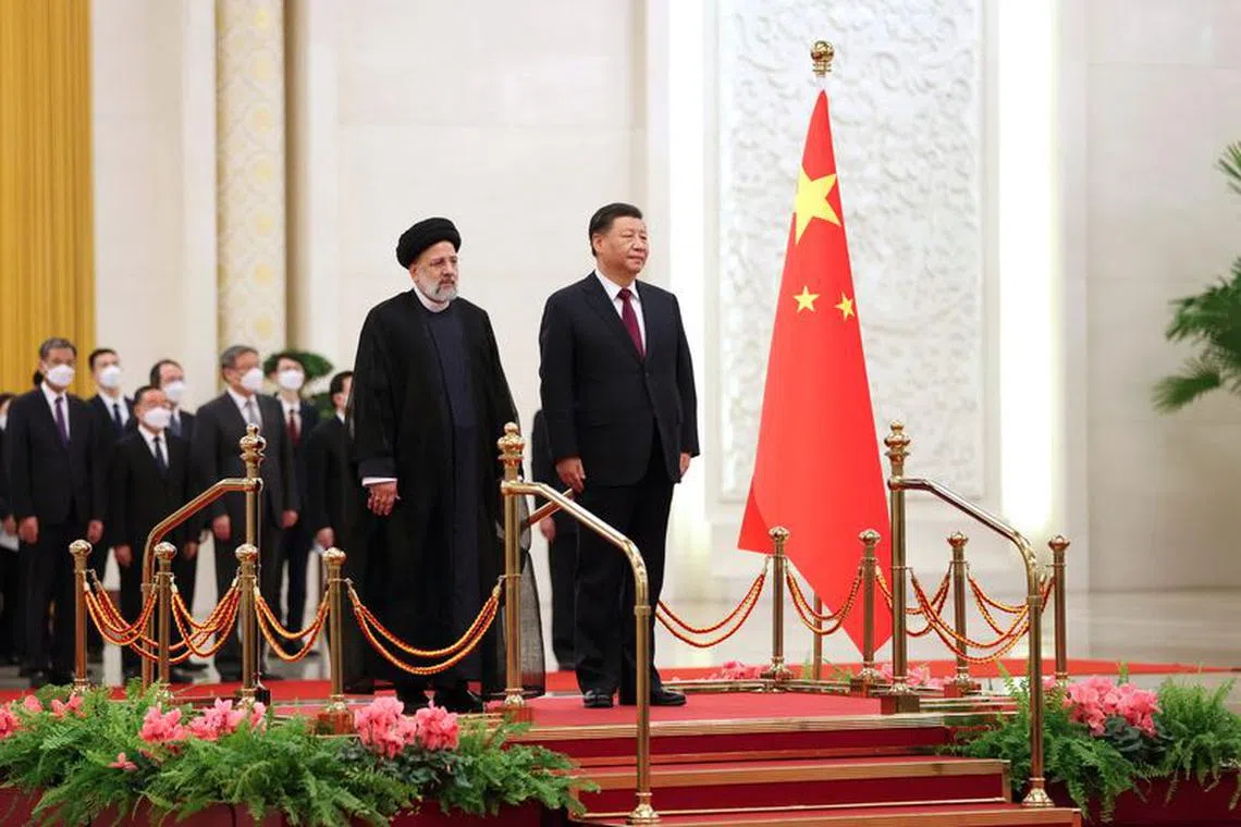 Iranian President Ebrahim Raisi stands next to Chinese President Xi Jinping during a welcoming ceremony in Beijing, China, February 14, 2023. Iran's President Website/WANA (West Asia News Agency)/Handout via REUTERS/ File Photo