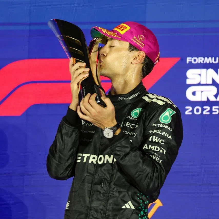 Mercedes-AMG Petronas Formula One Team driver George Russell kissing his trophy after winning the 2025 Formula One Singapore Airlines Singapore Grand Prix on Oct 5.