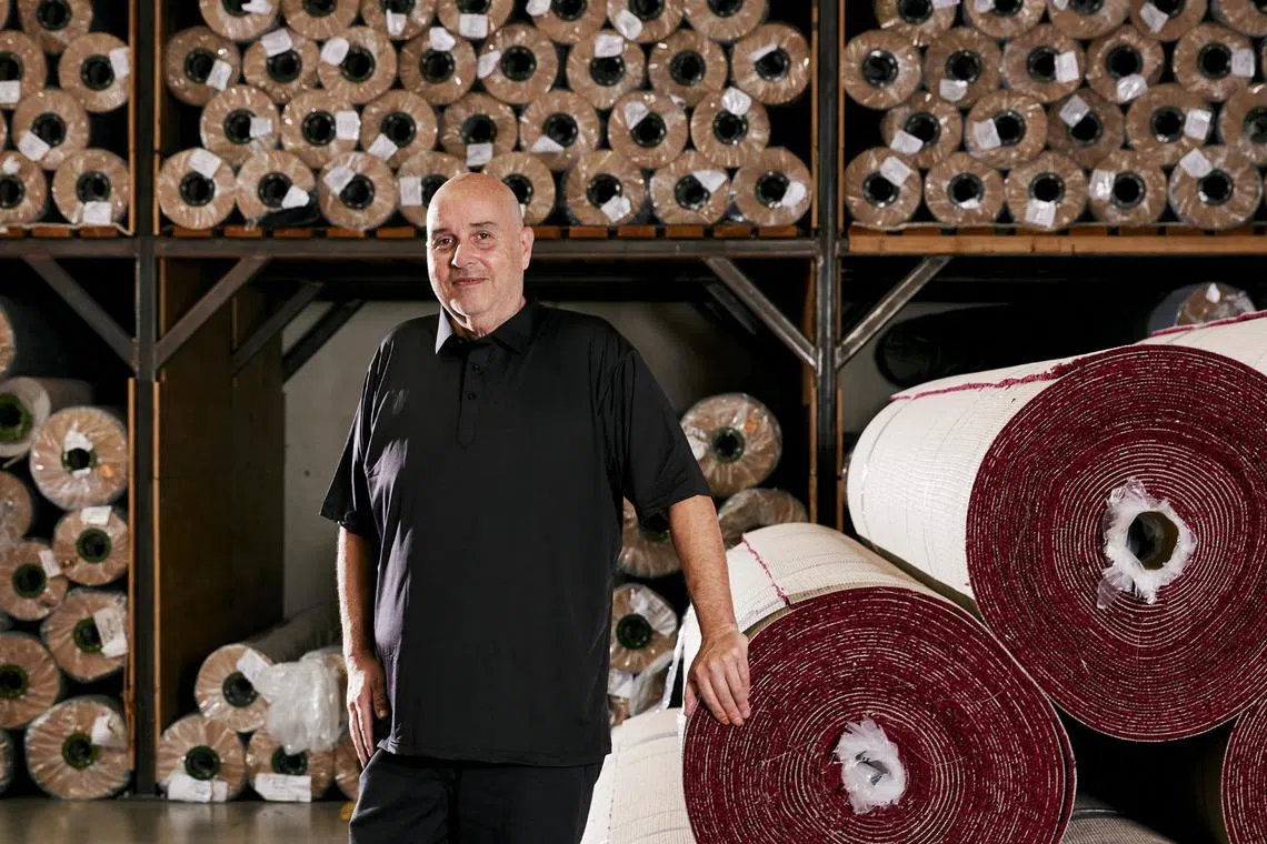 Event Carpet Pros co-founder Steve Olive with rolls of red carpet his company installed at the Dolby Theatre for the Oscars in Los Angeles.