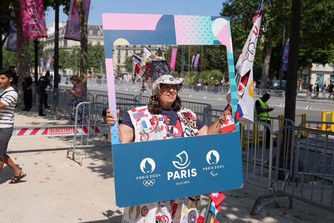 Vivianne Robinson, who has travelled to her seventh Olympic Games, holds a selfie frame, during the Paris 2024 Olympic Games, in Paris, France July 29, 2024. REUTERS/Leonardo Benassatto