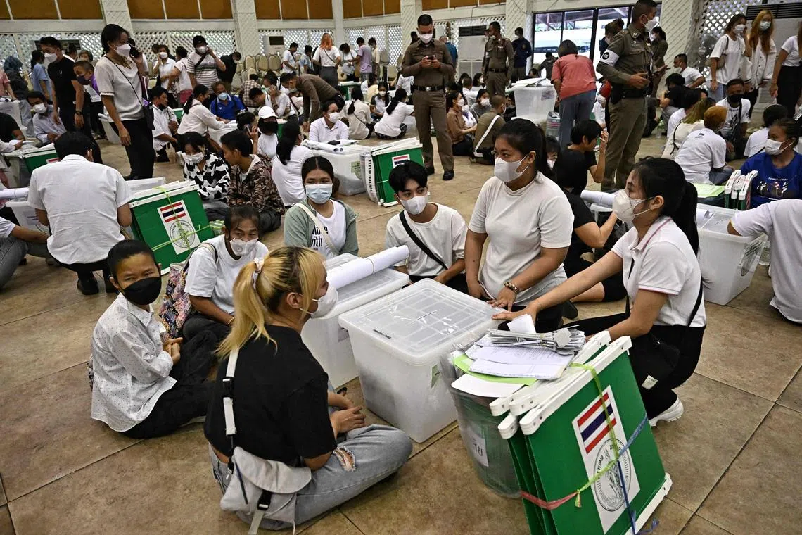 Election Commission volunteers inspecting ballots and voting materials on Saturday for distribution to polling booths in Bangkok. 