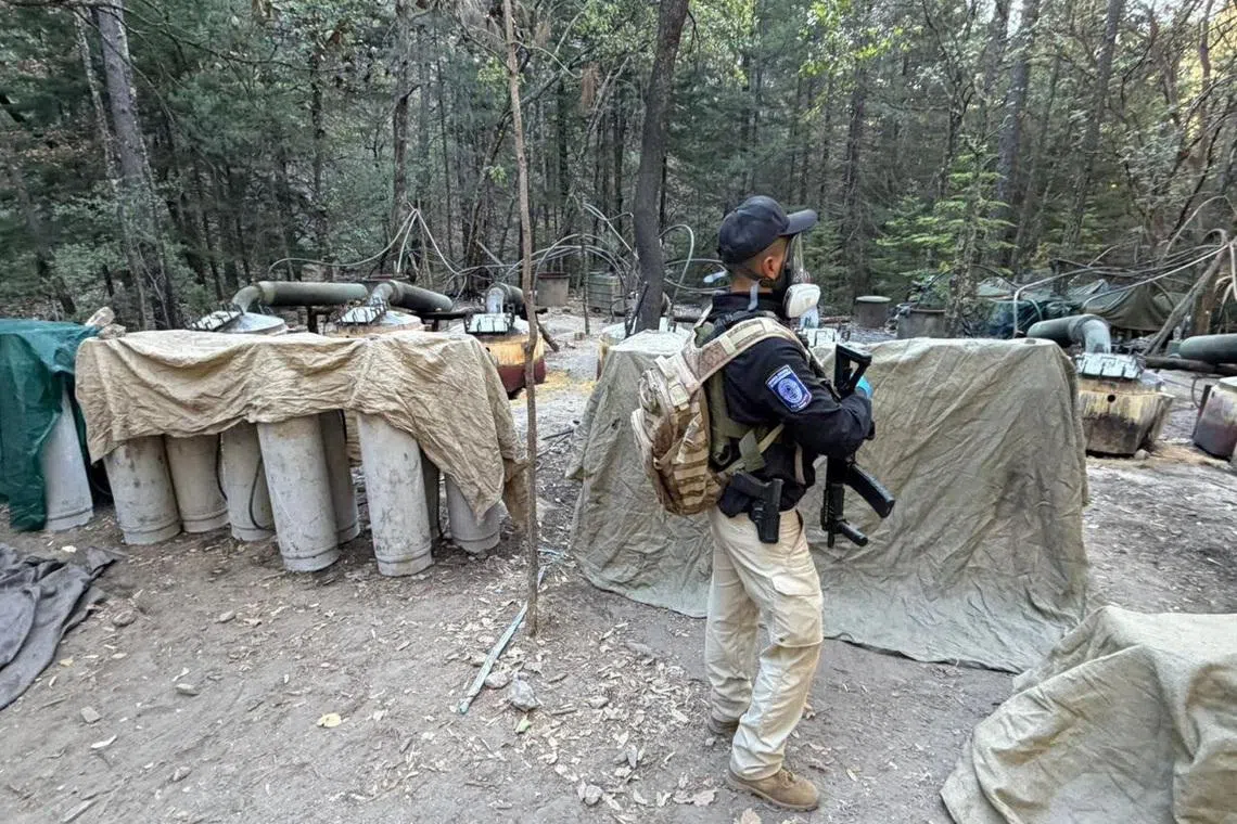 An investigative agent stands inside what the Attorney General's Office of Chihuahua said was a clandestine methamphetamine processing laboratory discovered during an operation by Mexican authorities in a mountainous area near Guachochi, in Chihuahua state, Mexico, in this handout photo distributed on April 18, 2026. Attorney General's Office of Chihuahua/Handout via REUTERS