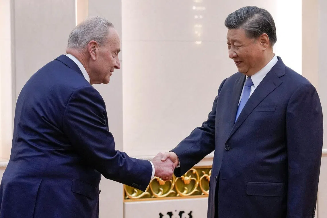 US Senate Majority Leader Chuck Schumer being greeted by Chinese President Xi Jinping before their bilateral meeting in the Great Hall of the People in Beijing.