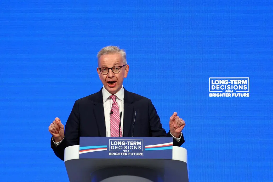 FILE PHOTO: British Secretary of State for Levelling Up, Housing and Communities Michael Gove speaks on stage at Britain's Conservative Party's annual conference in Manchester, Britain, October 3, 2023. REUTERS/Hannah McKay/File Photo