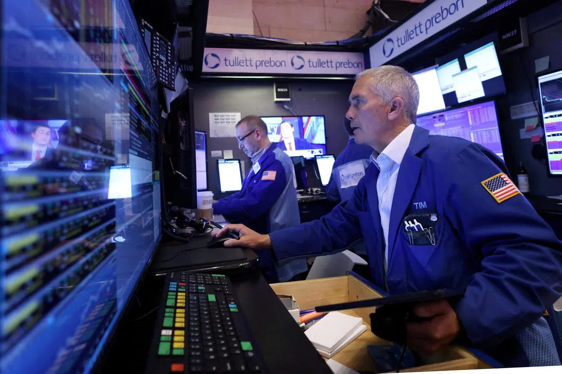 Traders work on the floor of the New York Stock Exchange, in New York City.