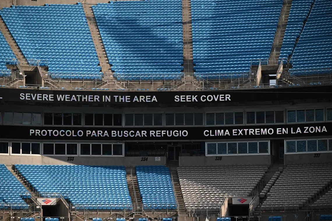 A giant screen informs on weather delay during the Club World Cup 2025 round of 16 football match between Portugal's Benfica and England's Chelsea at the Bank of America Stadium in Charlotte on June 28, 2025.   The Blues' 4-1 Club World Cup extra-time win over Benfica took 4hr 39mins to complete, following a two-hour stoppage due to a storm warning.