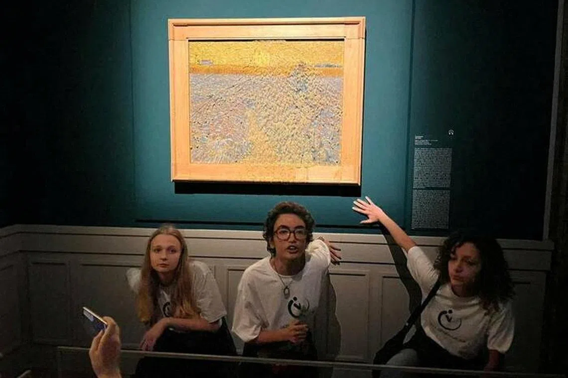 Activists from the Last Generation group of climate activists glue their hands to the wall after throwing soup at a Vincent Van Gogh's The Sower at Palazzo Bonaparte in Rome.