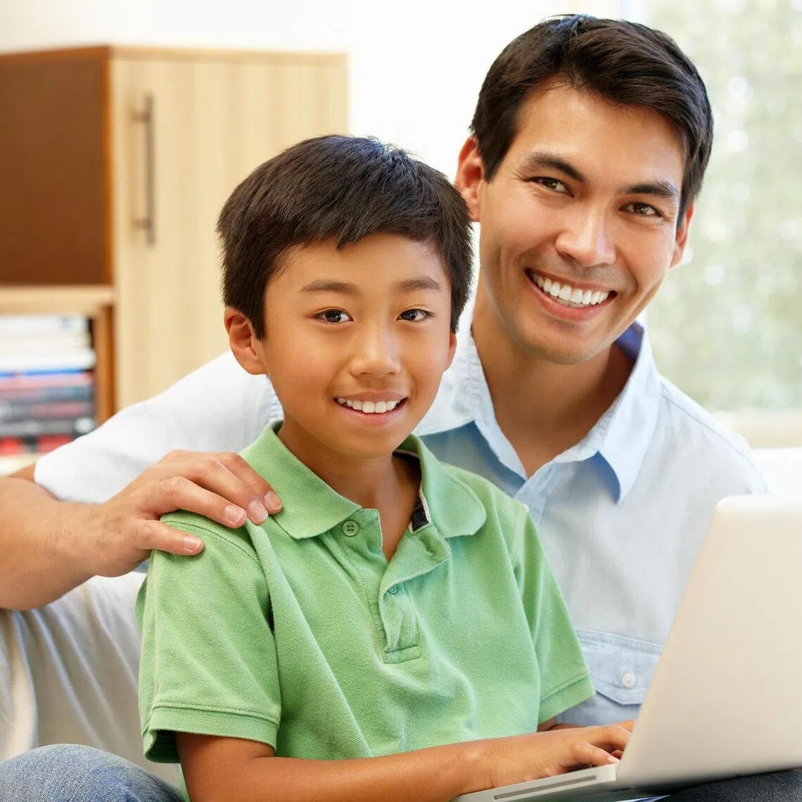 Father and son using laptop