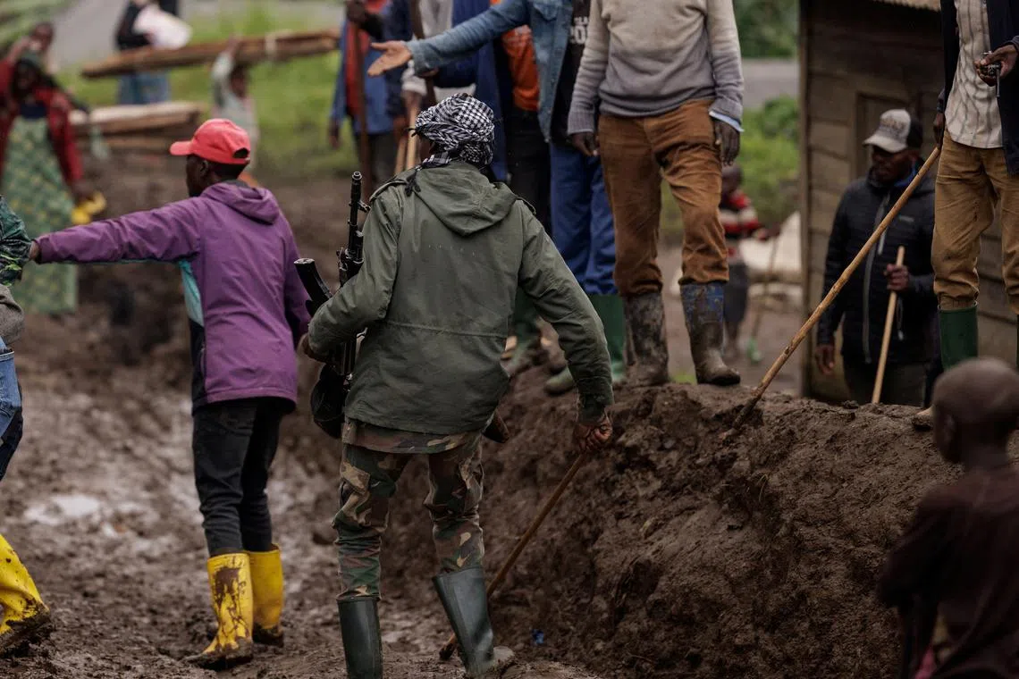 FILE PHOTO: An M23 rebel walks on a muddy road on the outskirts of Rubaya, which is controlled by M23 rebels, in eastern Democratic Republic of Congo, March 24, 2025. REUTERS/Zohra Bensemra/File Photo