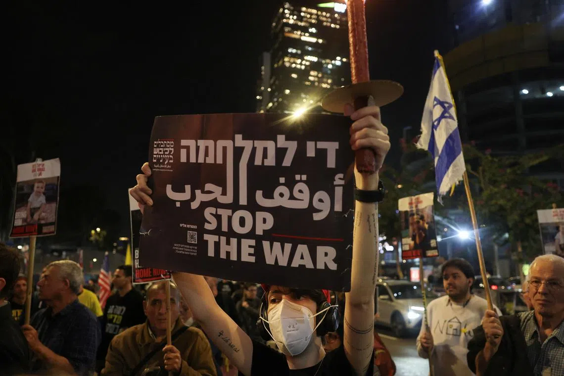 A person holds up a sign, as supporters of Israeli hostages, who were kidnapped during the deadly October 7 2023 attack by Hamas attend a protest to demand a deal to bring every hostage home at once, amid Gaza ceasefire negotiations, in Tel Aviv, Israel, January 15, 2025. REUTERS/Ronen Zvulun