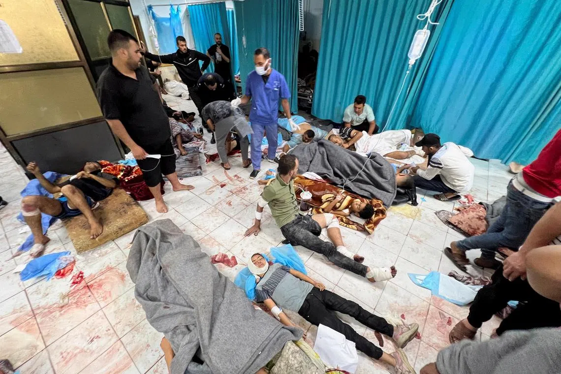 Palestinians wounded in air strikes lie on the ground as they are assisted at the Indonesian Hospital that is now the focus of Israel's military operations.
