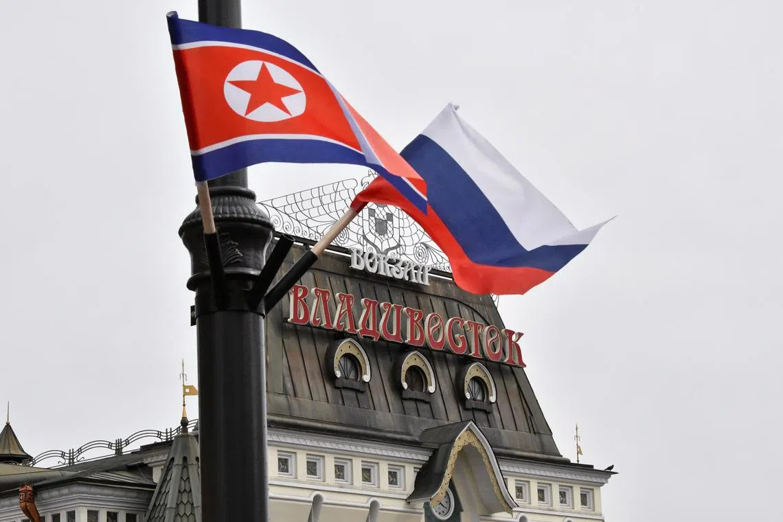 FILE PHOTO: State flags of Russia and North Korea fly in a street near a railway station during the visit of North Korea's leader Kim Jong Un to Vladivostok, Russia April 25, 2019. REUTERS/Yuri Maltsev
