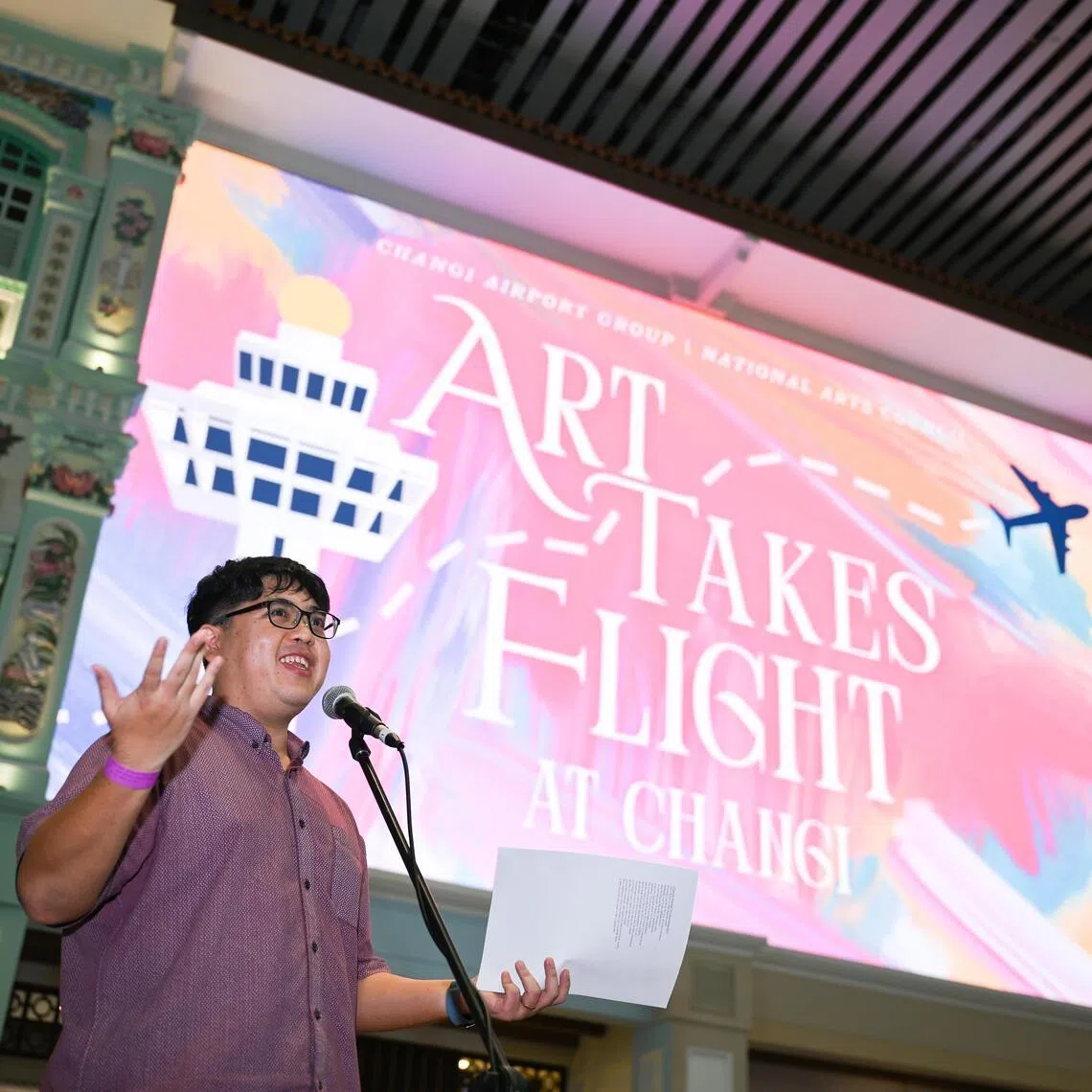 ST20260427-202662400188-Lim Yaohui-Justine Ong-jochangi27/
Poetry performance by Crispin Rodrigues at Heritage Zone of Changi Airport Terminal 4 on April 27, 2026.
The National Arts Council (NAC) and Changi Airport Group (CAG) announced a three-year partnership today, to explore ways to present Singapore’s artistic excellence to the world through Changi Airport which handles about 70 million passengers annually. This collaboration aims to create new opportunities for both local and international passengers to experience Singapore’s arts and culture, through a series of curated art displays, live performances and activations within the airport’s terminals.
Ms Low Yen Ling, Senior Minister of State for State for Culture, Community and Youth & Trade and Industry attended the launch event at Changi Airport Terminal 4 as Guest-of-Honour for the MOU signing, joined by NAC and CAG representatives, and local artists who presented live poetry and music to celebrate the partnership.
(ST PHOTO: LIM YAOHUI)