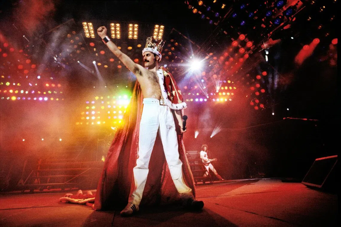Freddie Mercury, the lead singer of Queen at Wembley Stadium in 1986 wearing his iconic crown and cloak during a performance. 
