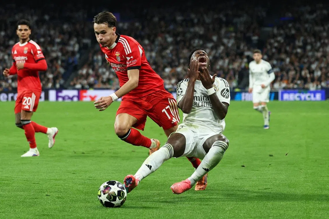 Real Madrid's Vinicius Junior in action with Benfica's Amar Dedic, at the UEFA Champions League second leg match in Santiago Bernabeu, Madrid, Spain, on Feb 25, 2026.