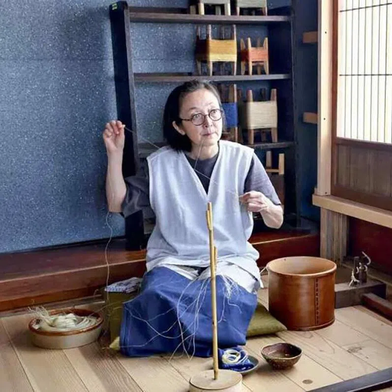 Eriko Yamauchi makes thread in a quiet environment where bird songs can be heard, in Showa, Fukushima Prefecture.