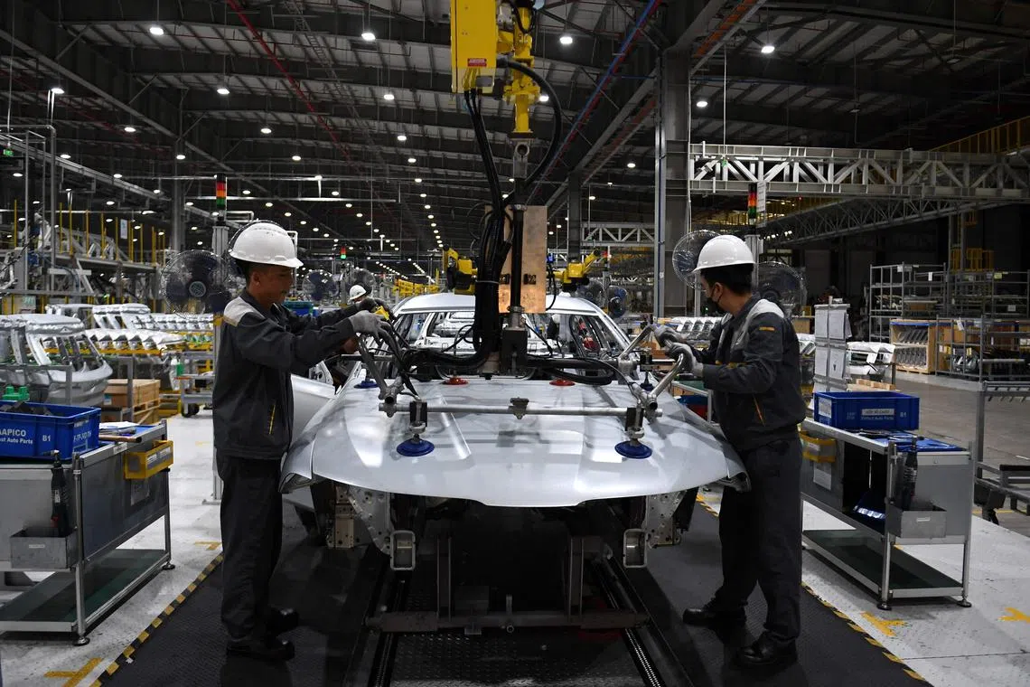 Workers assembling an electric car at the VinFast electric car plant in Haiphong on Aug 26, 2022.