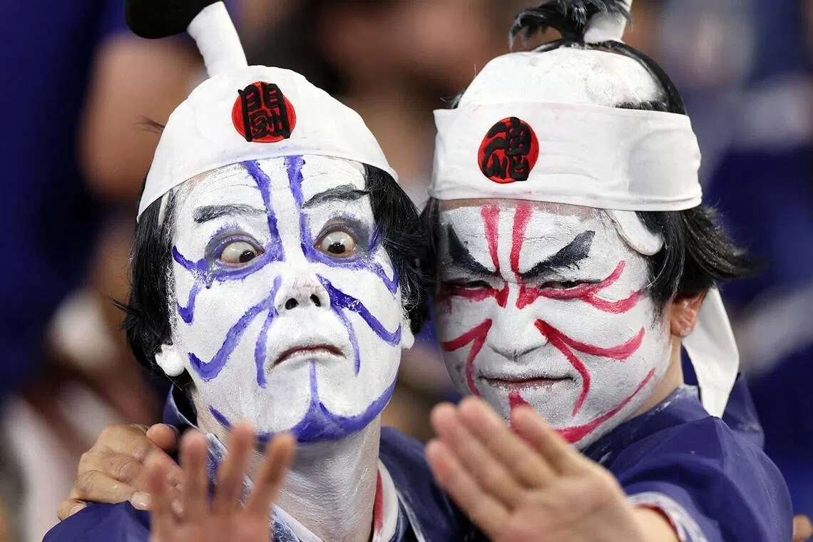 Japanese fans posing for a photo during the World Cup football match between Tunisia and Japan at the Monterrey Stadium in Guadalupe, Mexico, on June 20.