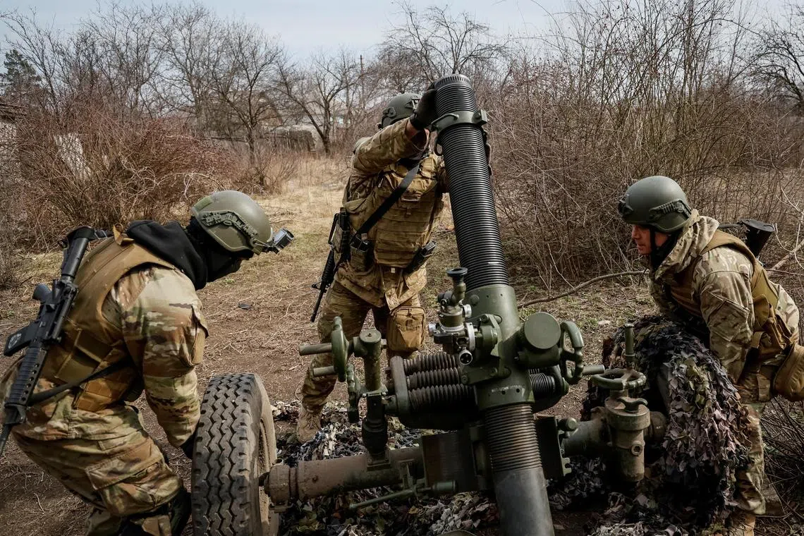 Servicemen with the Freedom of Russia Legion under the Ukrainian Army prepare to fire a mortar at a Russian military position, in Ukraine's Donetsk region, on March 21, 2023.