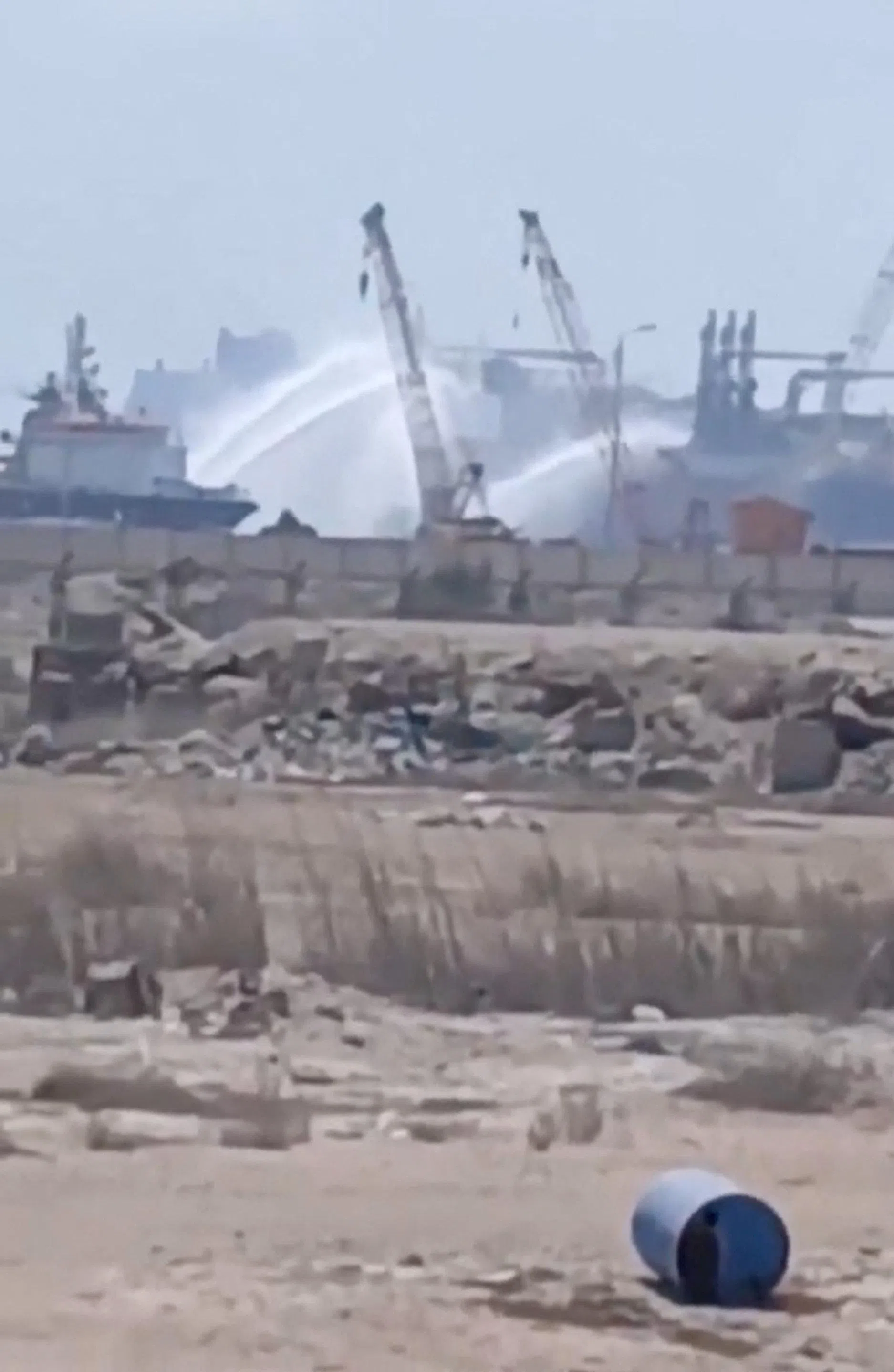 Water jets are fired at a gas tanker after a drone strike, according to maritime security firm Ambrey, at Damietta port, Egypt, on July 29.