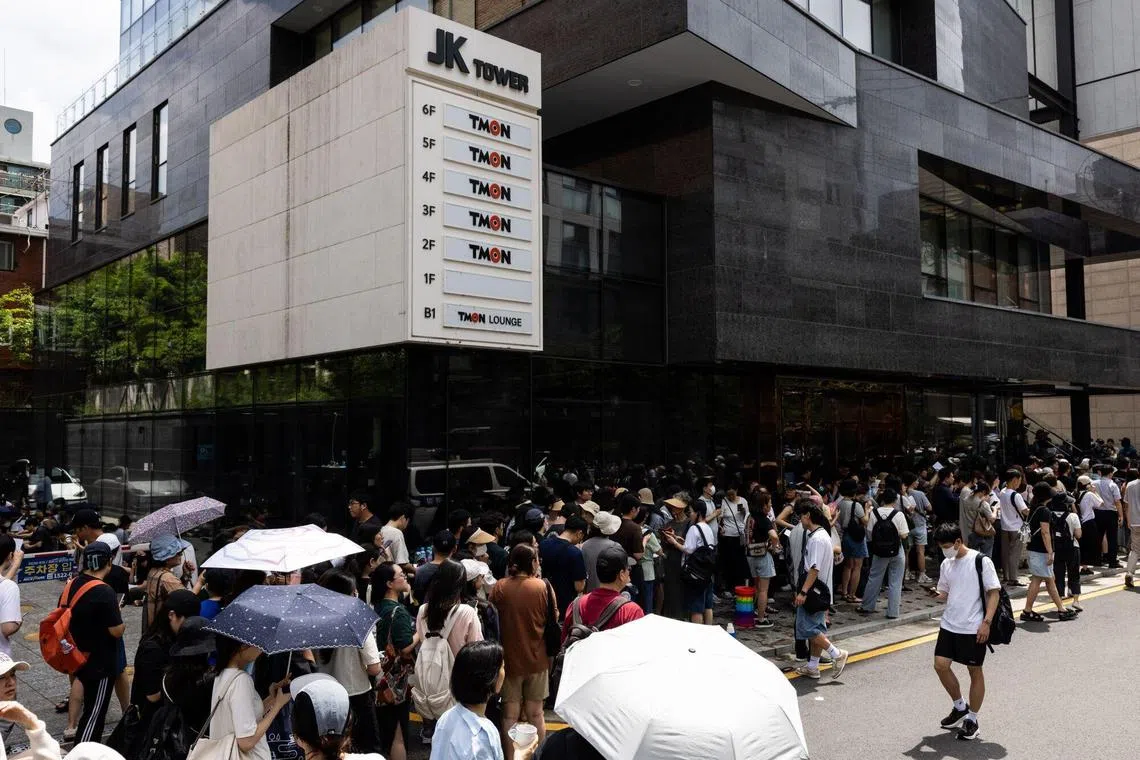 Customers wait in line to get refunds outside an office of TMON, the e-commerce platform owned by Singapore-based Qoo10, in Seoul on July 26, 2024. 