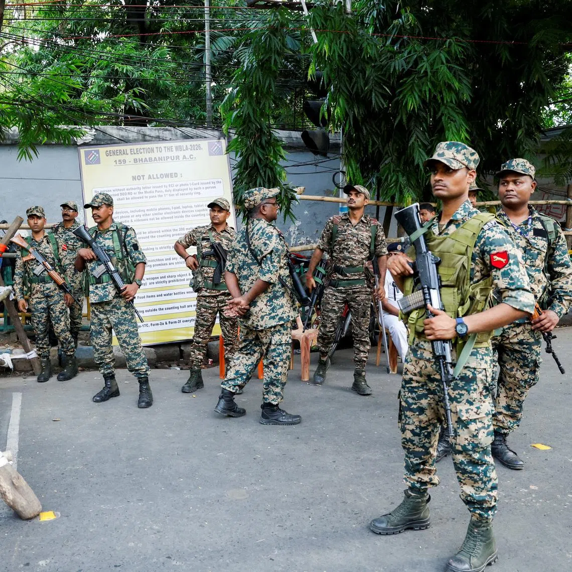 Security personnel stand guard during vote counting for the West Bengal legislative assembly election polls outside a counting centre in Kolkata, India, May 4, 2026.