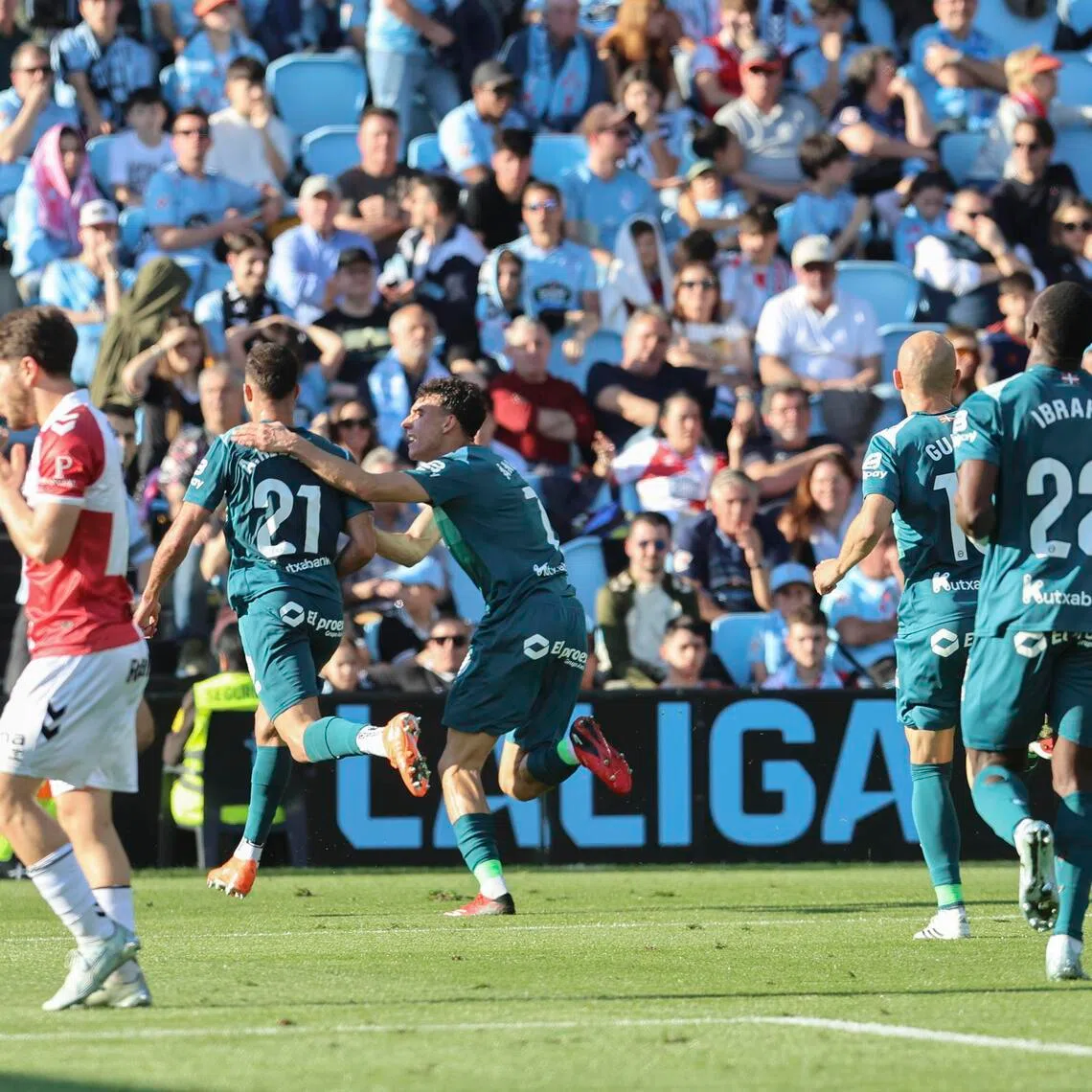 Alaves players celebrate the winning goal scored by Abde Rebbach against Celta Vigo in their Spanish La Liga soccer match in Vigo on March 22, 2026.